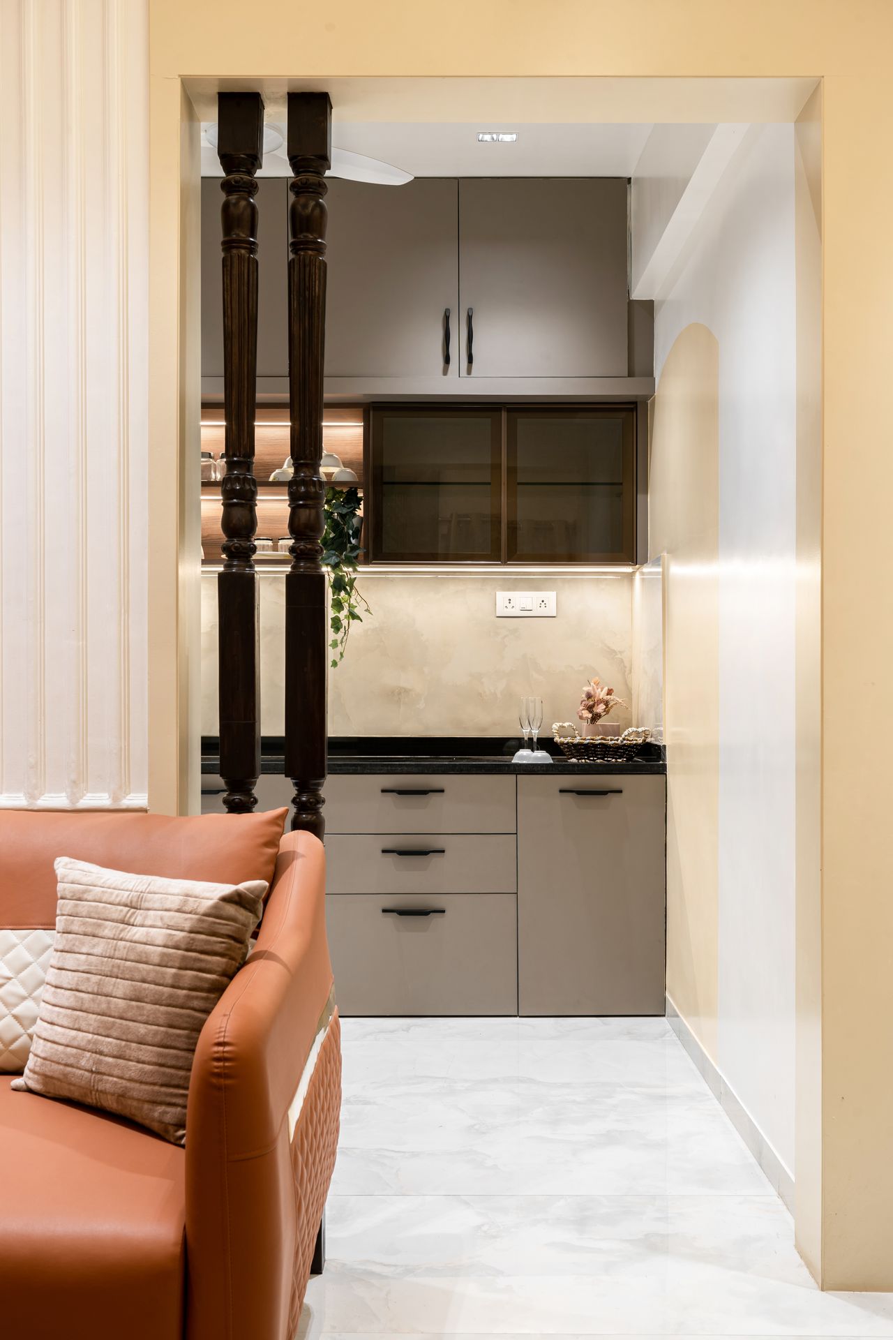 Kitchen framed by turned wooden pillars